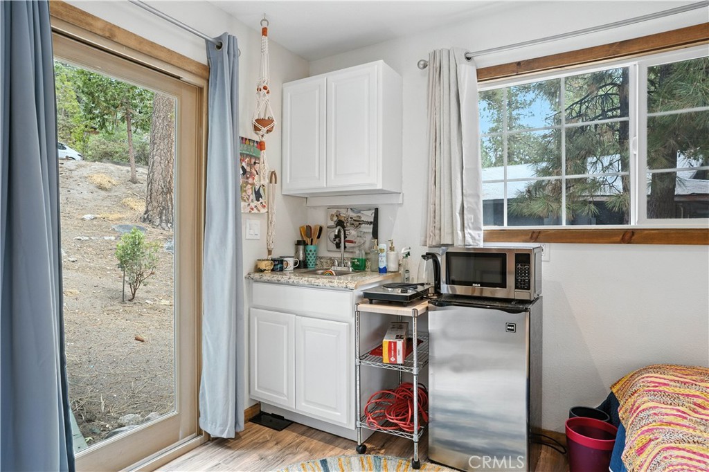 24990 Marion Ridge Drive Idyllwild, CA 92549 - Photo 22 of 41 a kitchen with stainless steel appliances a microwave a stove and white cabinets