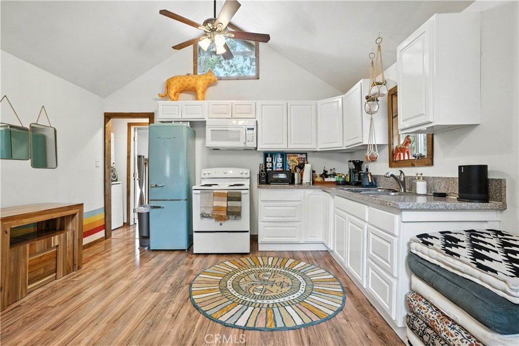 24990 Marion Ridge Drive Idyllwild, CA 92549 - Photo 8 of 41 a kitchen with stainless steel appliances granite countertop a stove a sink dishwasher and a refrigerator with wooden floor