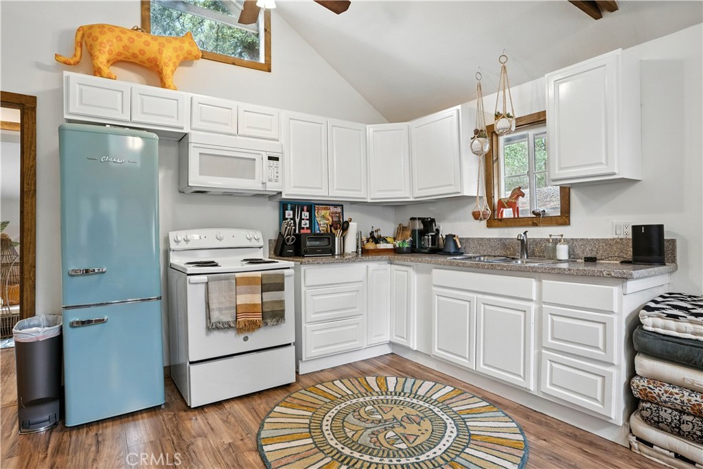 24990 Marion Ridge Drive Idyllwild, CA 92549 - Photo 9 of 41 a kitchen with a white stove top oven and cabinets