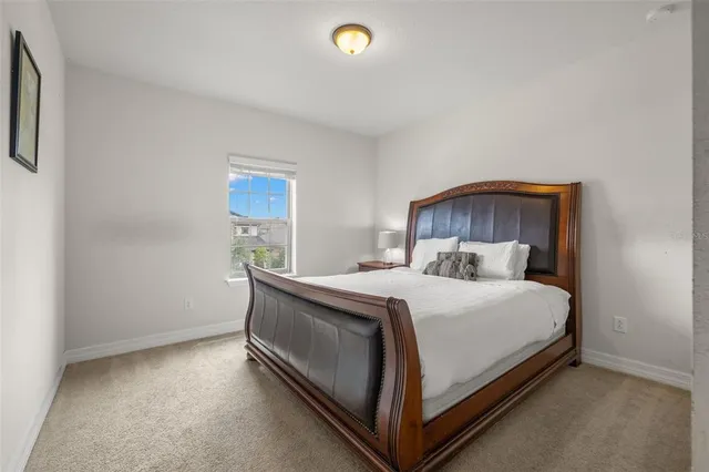 a bed sitting in a bedroom next to a window