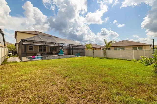 a view of a house with a backyard porch and sitting area