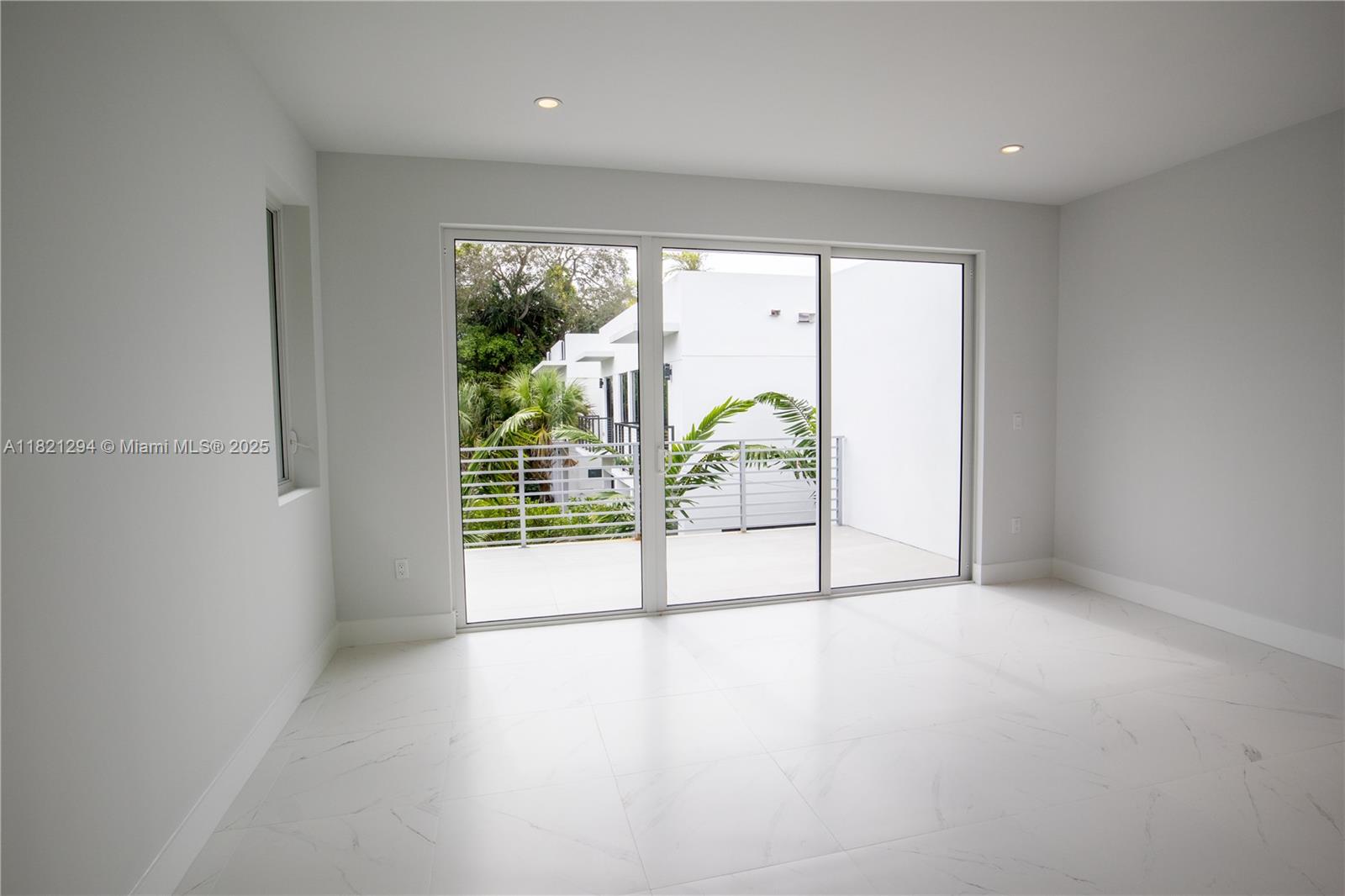 3374 Day Avenue, Unit A Miami, FL 33133 - Photo 11 of 13 an empty room with sliding glass door and mountain view