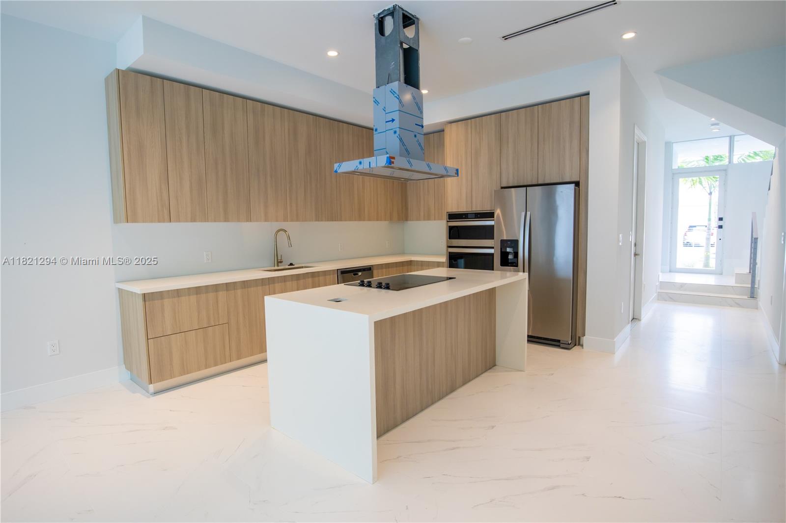 3374 Day Avenue, Unit A Miami, FL 33133 - Photo 2 of 13 a kitchen with a refrigerator a stove top oven a counter space and wooden floor