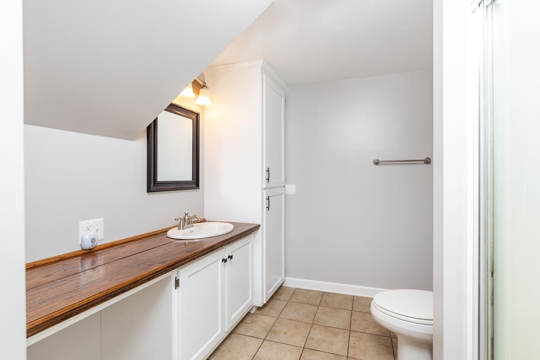 915 Sterrett Road Fairfield, VA 24435 - Photo 54 of 75 a bathroom with a granite countertop sink a toilet and a mirror