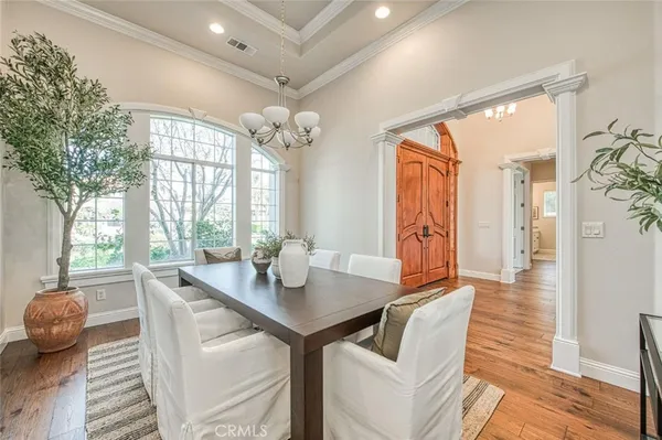 a view of a dining room with furniture wooden floor and chandelier