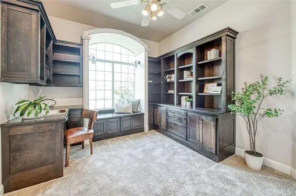 a living room with furniture and flowers