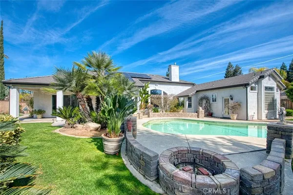 a view of a house with backyard sitting area and porch