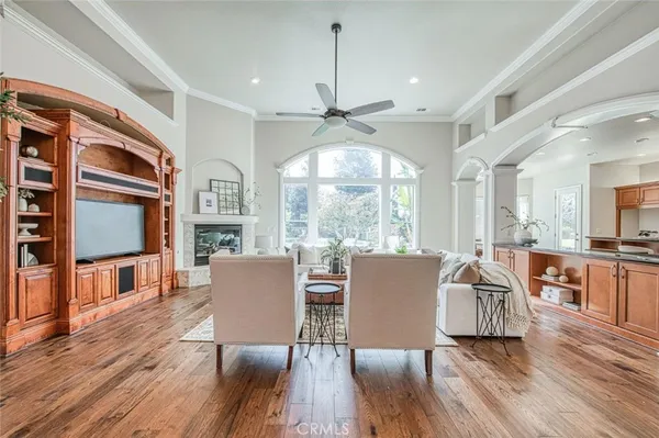 a living room with fireplace furniture and a wooden floor
