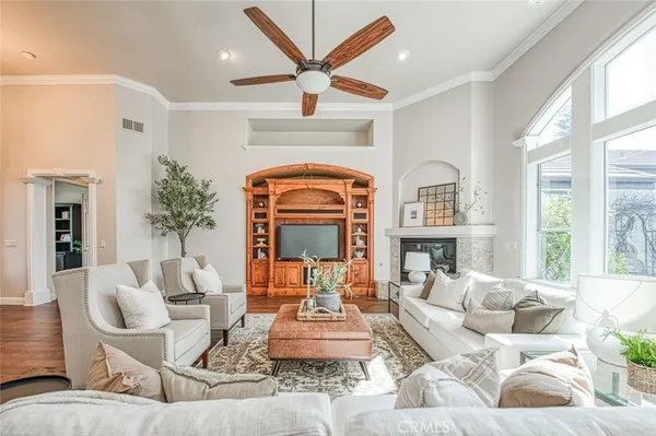 a living room with furniture fireplace and a large window