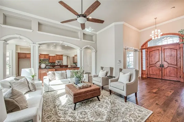 a living room with furniture a table and a large window