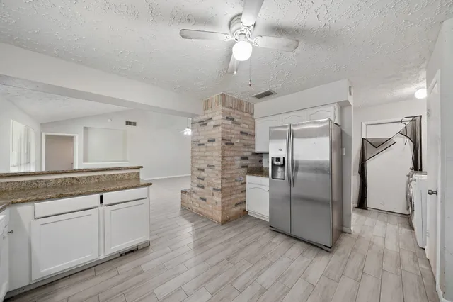 a kitchen with stainless steel appliances a refrigerator sink and cabinets