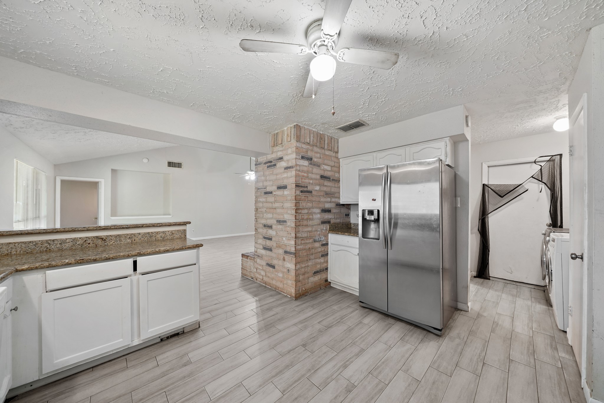 13923 Ludgate Pass Houston, TX 77034 - Photo 12 of 25 a kitchen with stainless steel appliances a refrigerator sink and cabinets
