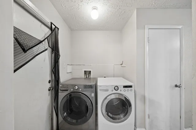 a view of a hallway with washer and dryer