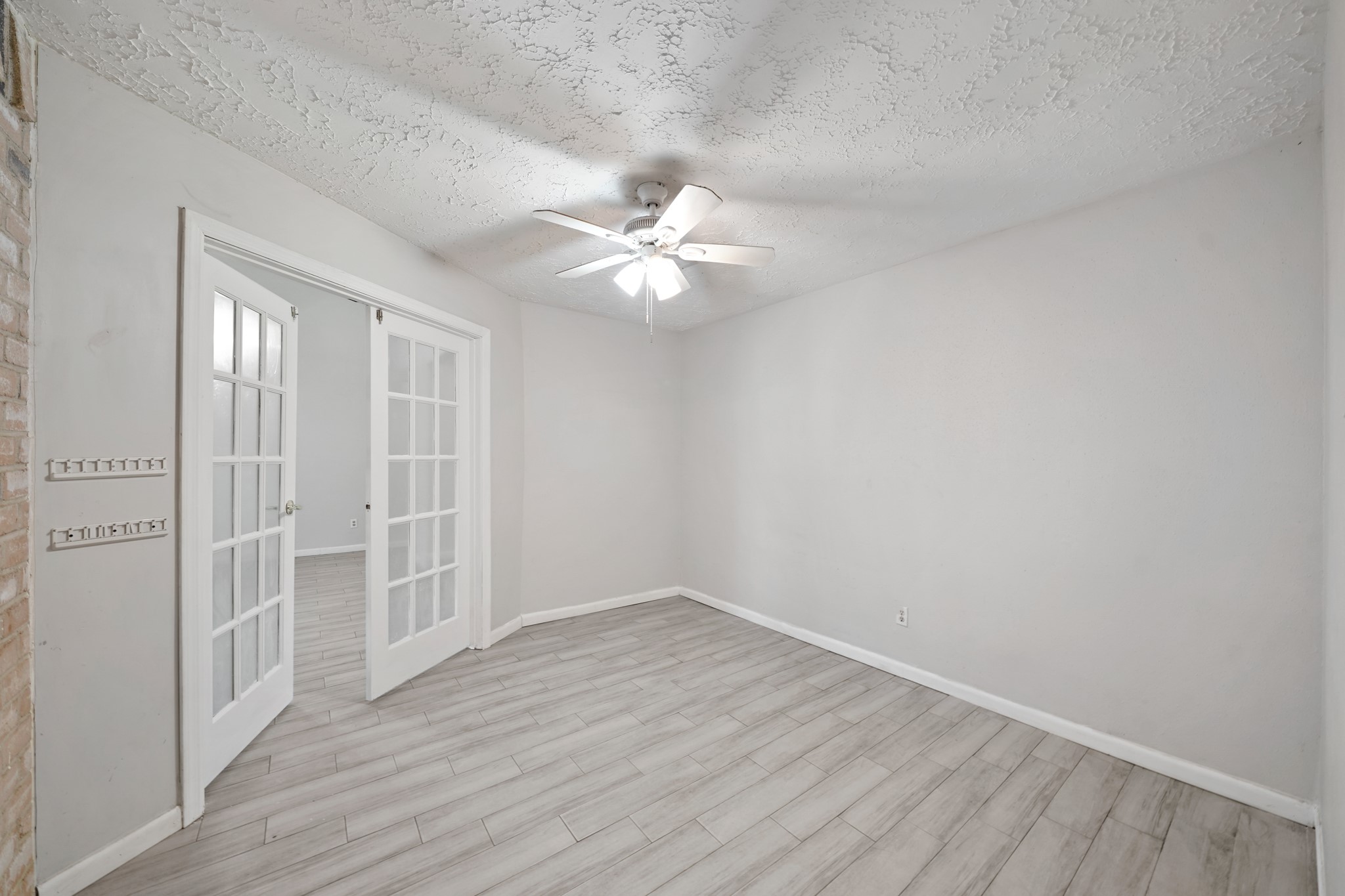 13923 Ludgate Pass Houston, TX 77034 - Photo 14 of 25 wooden floor in an empty room with a window