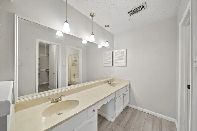 a bathroom with a double vanity sink and mirror