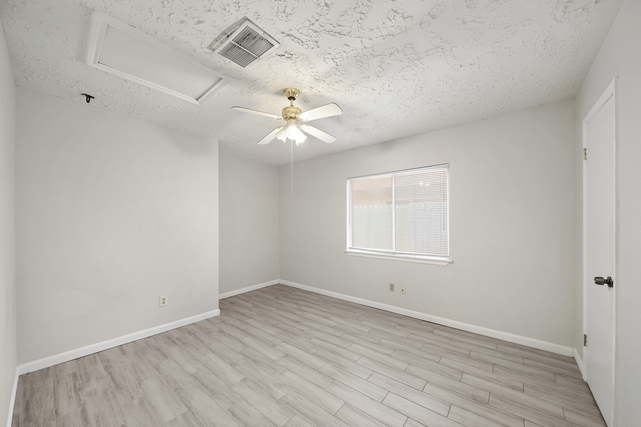 13923 Ludgate Pass Houston, TX 77034 - Photo 20 of 25 an empty room with wooden floor and window