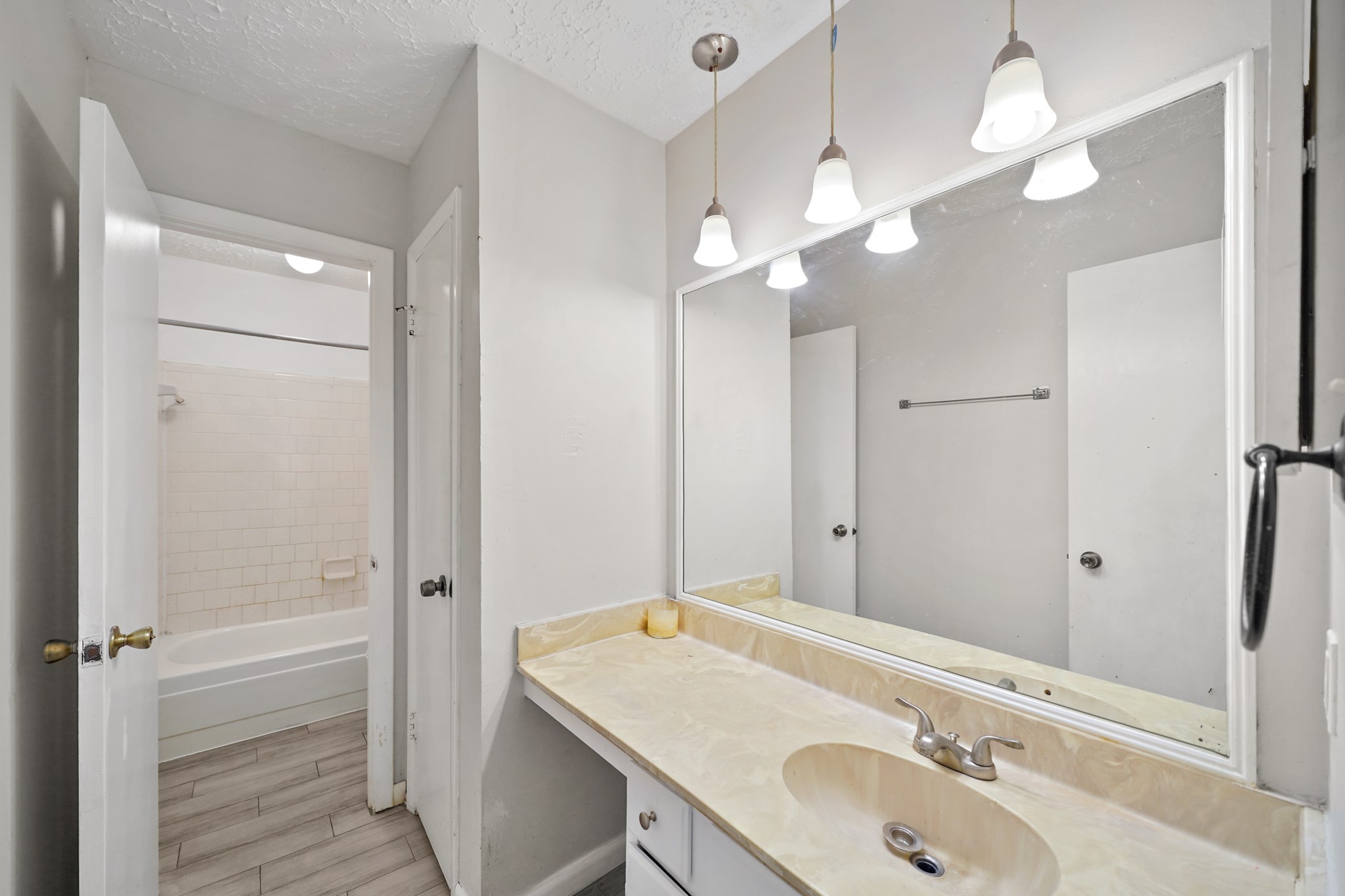 13923 Ludgate Pass Houston, TX 77034 - Photo 21 of 25 a bathroom with a sink a light fixture and a mirror
