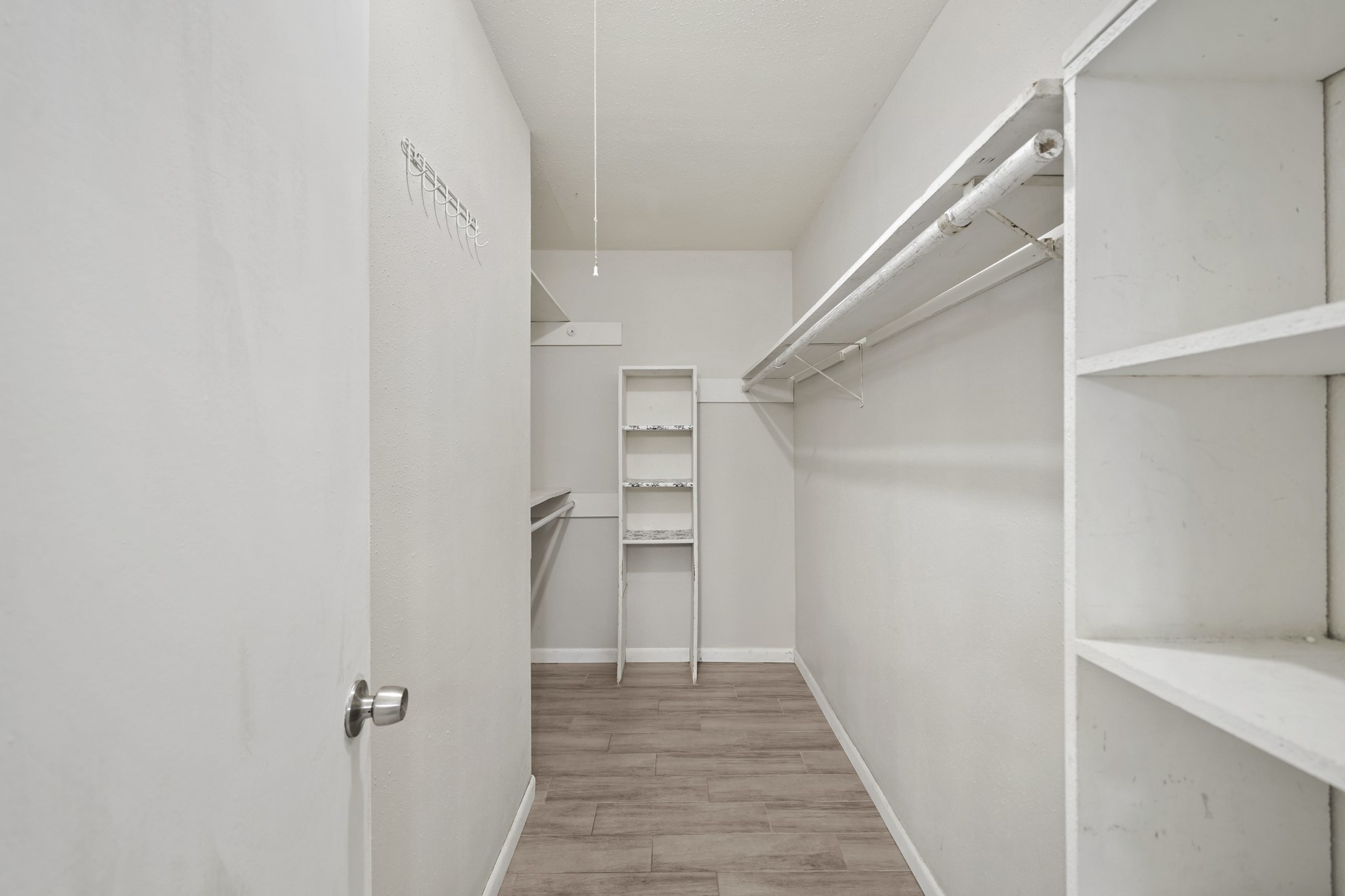 13923 Ludgate Pass Houston, TX 77034 - Photo 22 of 25 a view of a hallway with closet and a window