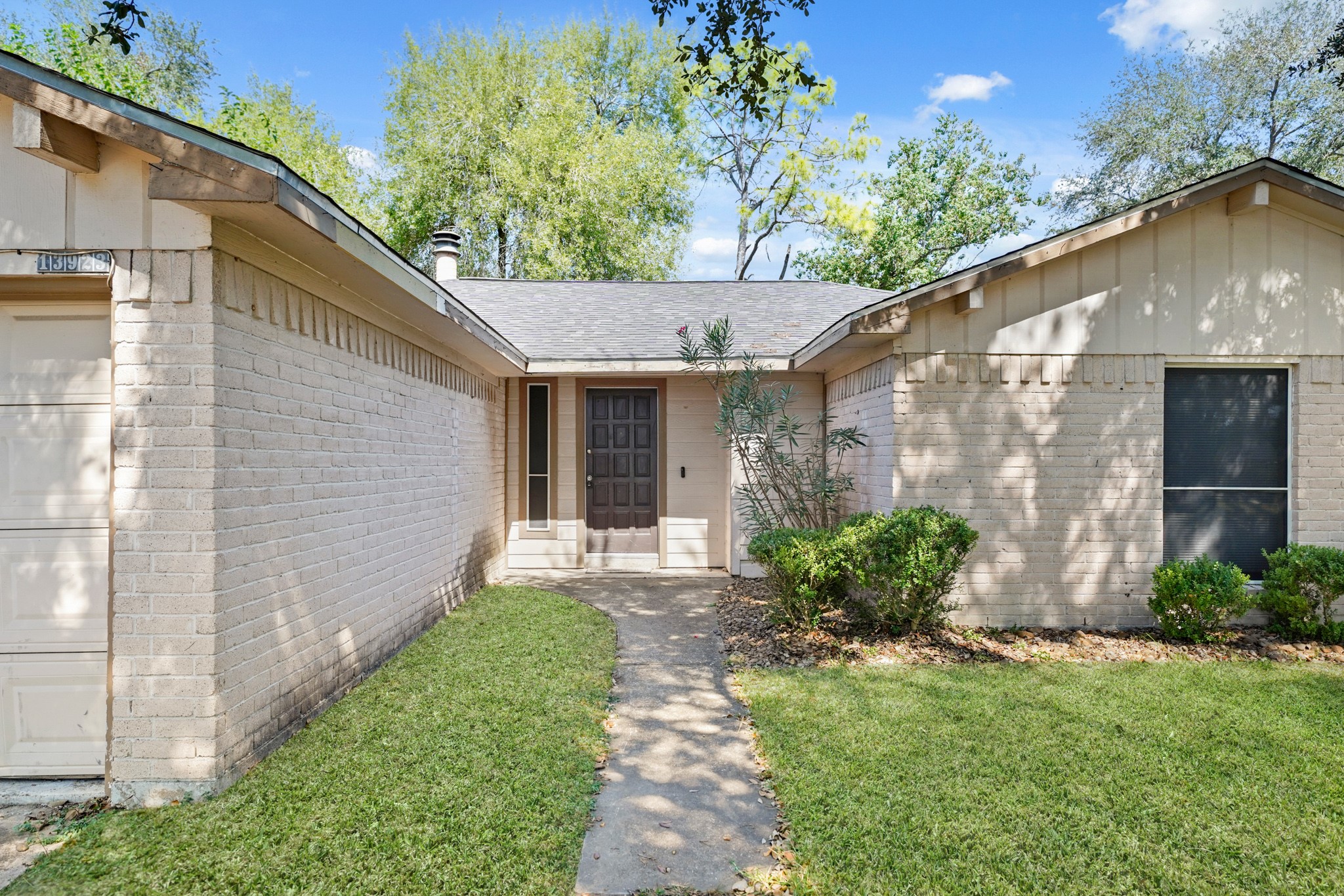 13923 Ludgate Pass Houston, TX 77034 - Photo 3 of 25 a front view of a house with garden