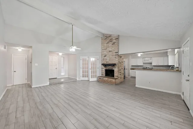 a view of kitchen with granite countertop stove top oven and cabinets