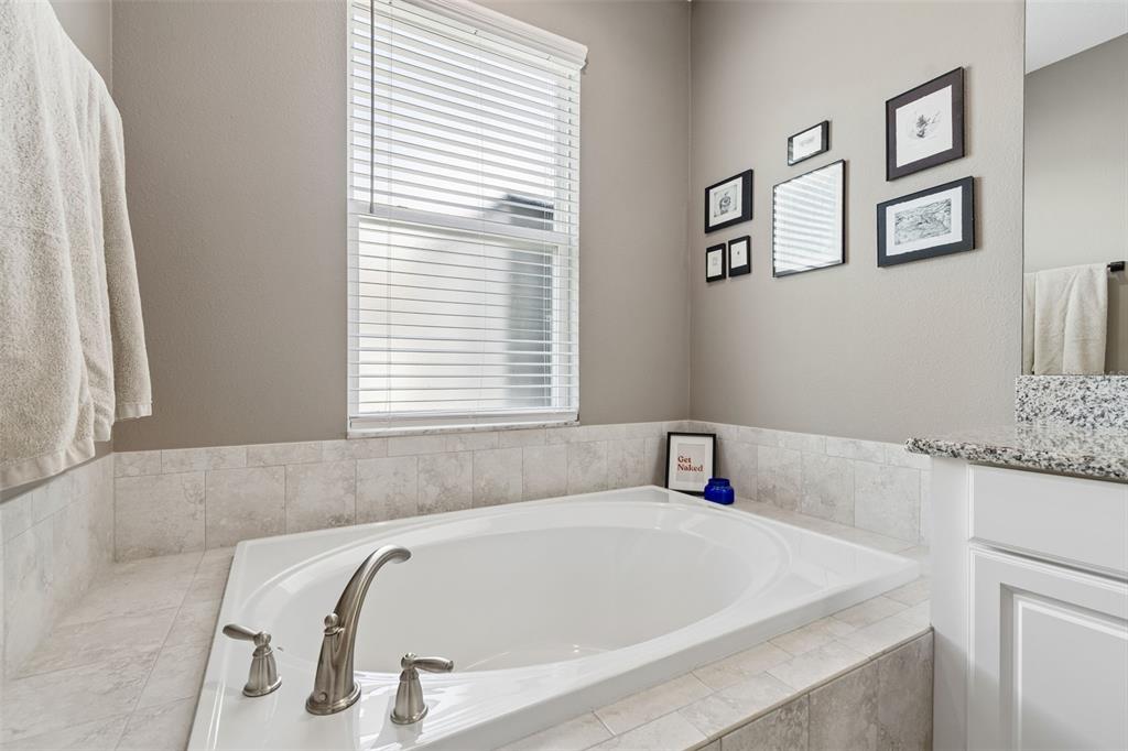 18078 Romanesque Court Spring Hill, FL 34610 - Photo 59 of 98 a white bath tub sitting in a bathroom next to a window