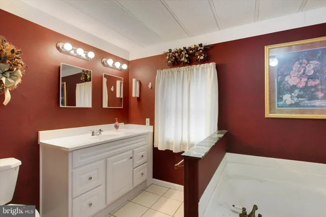 a bathroom with a sink a vanity and a mirror