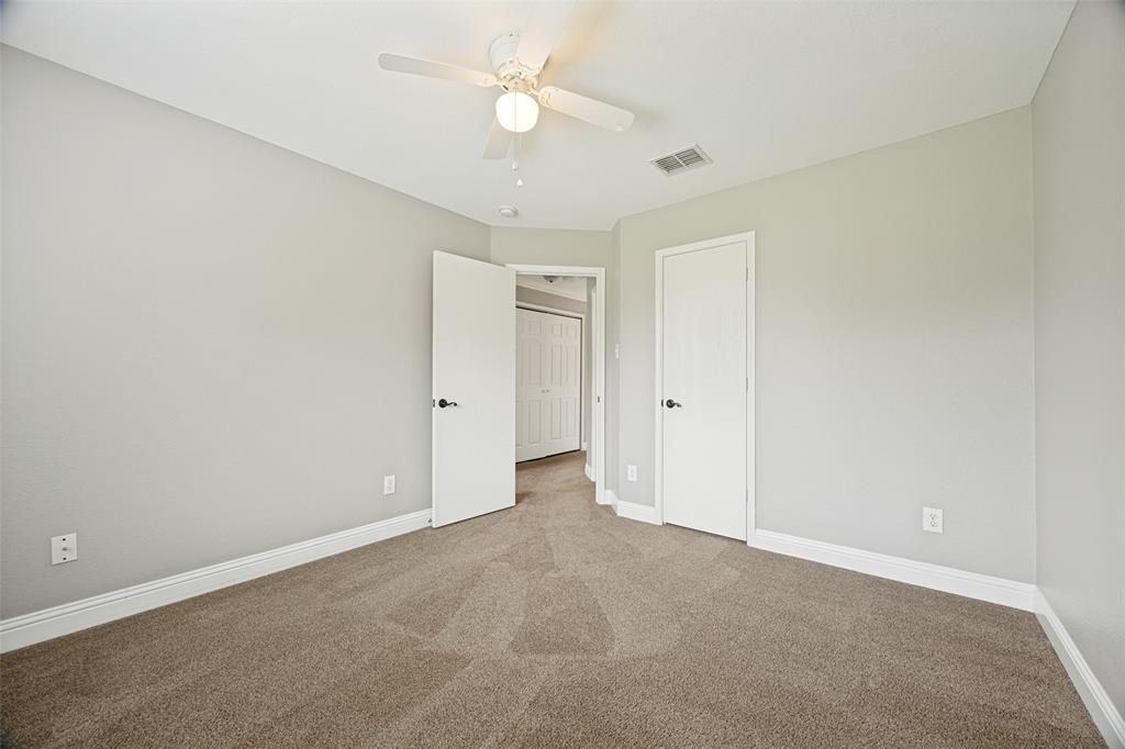 1601 Elm Street Anna, TX 75409 - Photo 16 of 25 an empty room with a ceiling fan and a fan