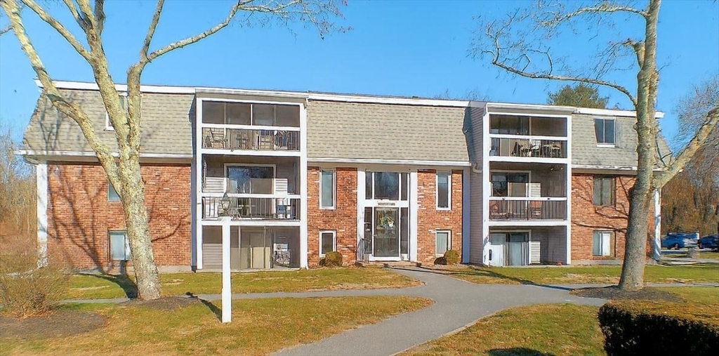 a front view of a building with a garden