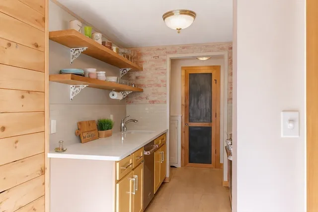 a kitchen with stainless steel appliances a stove a sink a refrigerator and cabinets