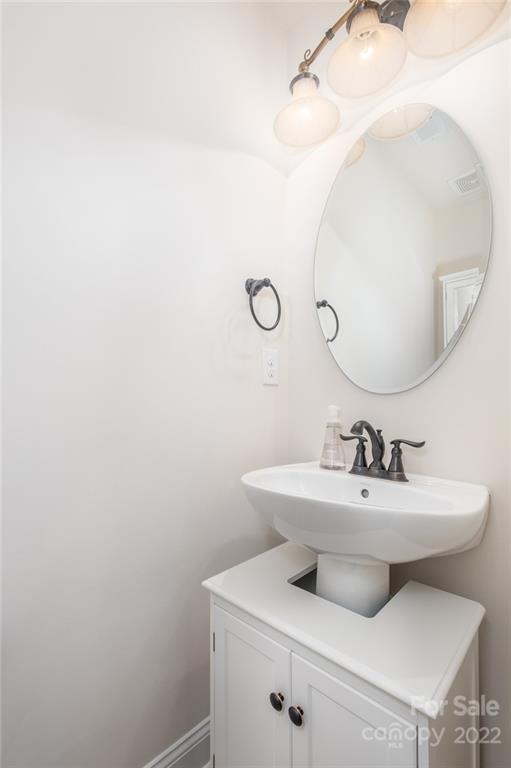 266 Streamwood Road Troutman, NC 28166 - Photo 32 of 35 a bathroom with a sink mirror and vanity