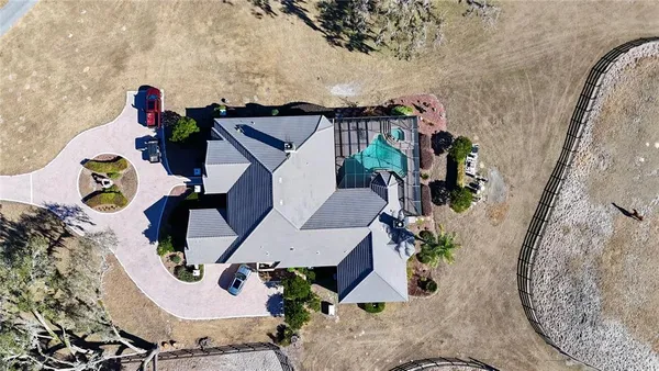 an aerial view of a house with a yard