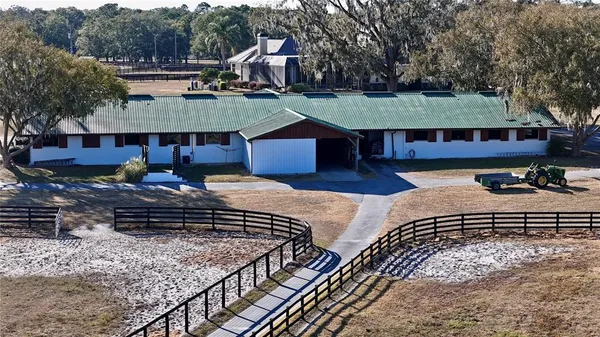 a view of a house with backyard porch and sitting area