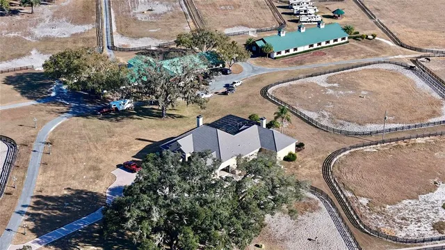 an aerial view of a house with a yard and garden