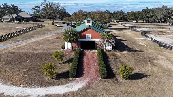an aerial view of a house yard and lake view