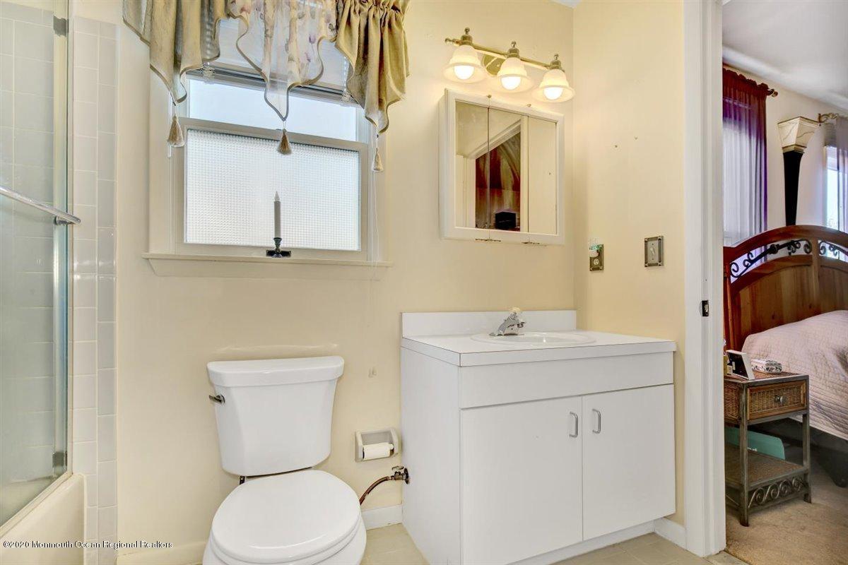 19 Independence Way Howell, NJ 07731 - Photo 22 of 27 a bathroom with a toilet sink and mirror
