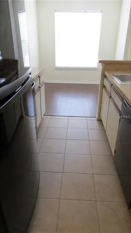 a kitchen with a sink a stove and a microwave oven