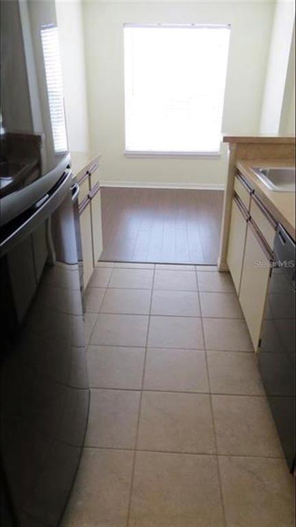1083 South Hiawassee Road, Unit 635 Orlando, FL 32835 - Photo 13 of 16 a kitchen with a sink a stove and a microwave oven