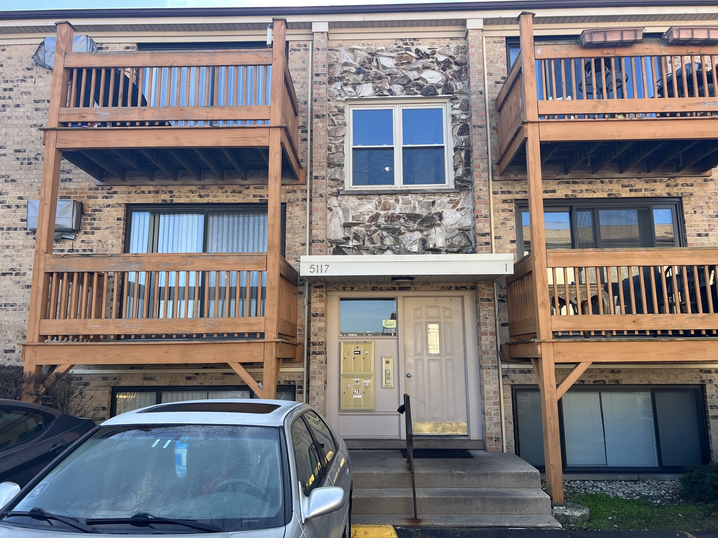 5117 North East River Road, Unit 2A Chicago, IL 60656 - Photo 1 of 32 a view of front door of house with a deck