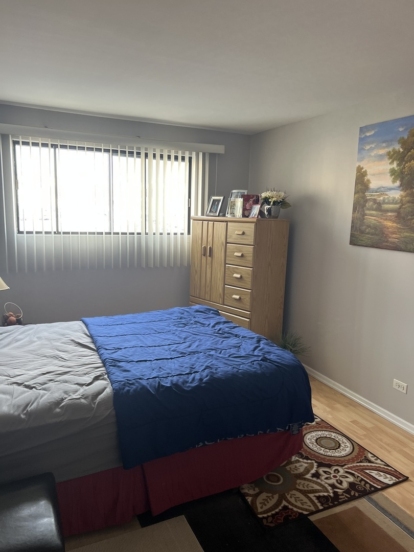 5117 North East River Road, Unit 2A Chicago, IL 60656 - Photo 15 of 32 a bedroom with a bed and a window