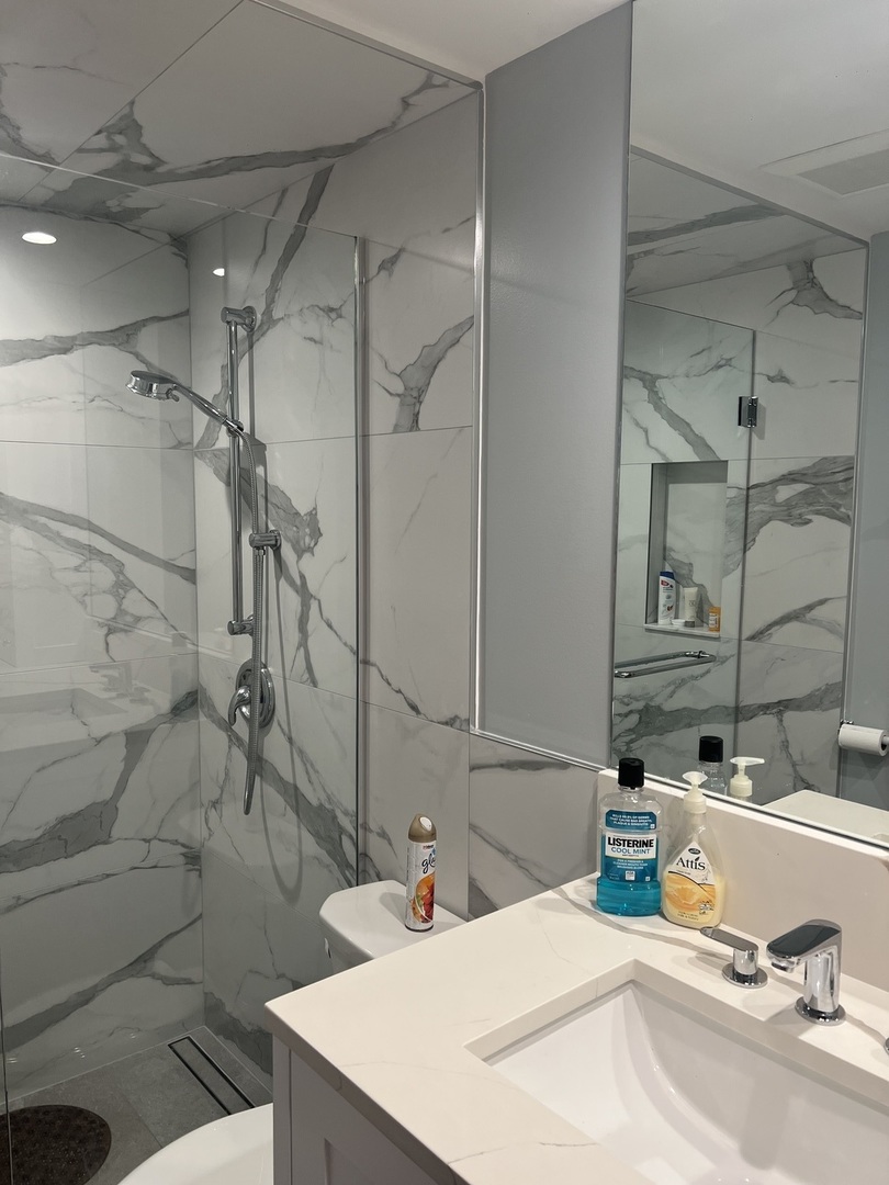 5117 North East River Road, Unit 2A Chicago, IL 60656 - Photo 18 of 32 a bathroom with a sink and a mirror