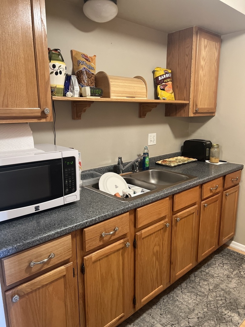 5117 North East River Road, Unit 2A Chicago, IL 60656 - Photo 24 of 32 a kitchen with stainless steel appliances granite countertop a sink a stove and cabinets