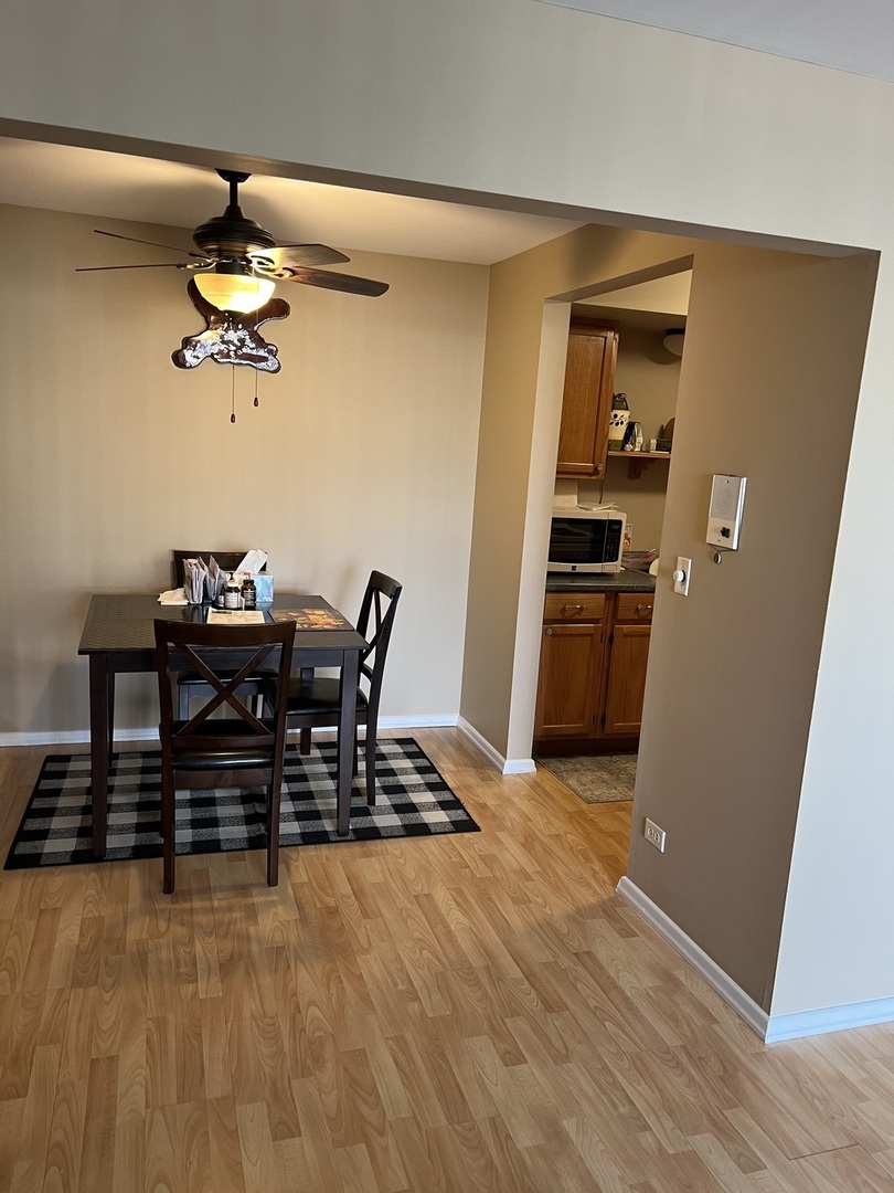 5117 North East River Road, Unit 2A Chicago, IL 60656 - Photo 27 of 32 a dining room with kitchen island stainless steel appliances a stove and a refrigerator