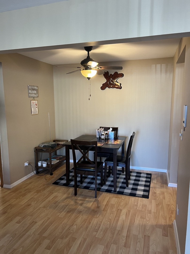 5117 North East River Road, Unit 2A Chicago, IL 60656 - Photo 28 of 32 a view of a dining room with furniture and wooden floor