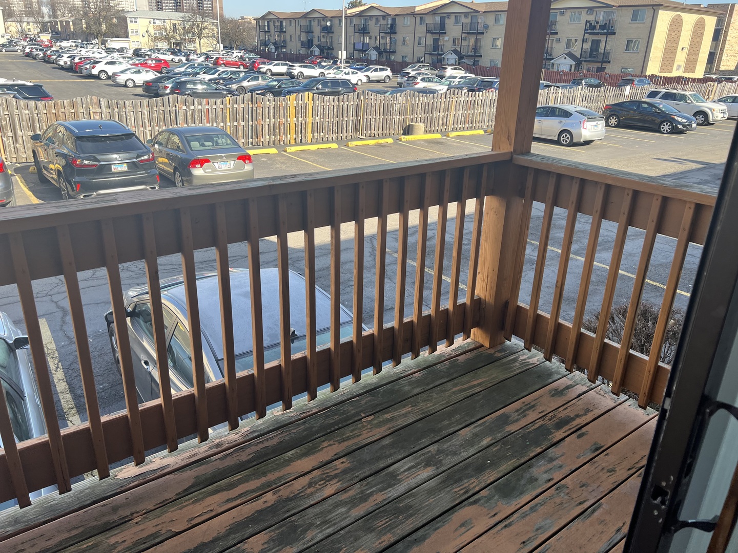 5117 North East River Road, Unit 2A Chicago, IL 60656 - Photo 6 of 32 a view of a balcony with wooden chairs