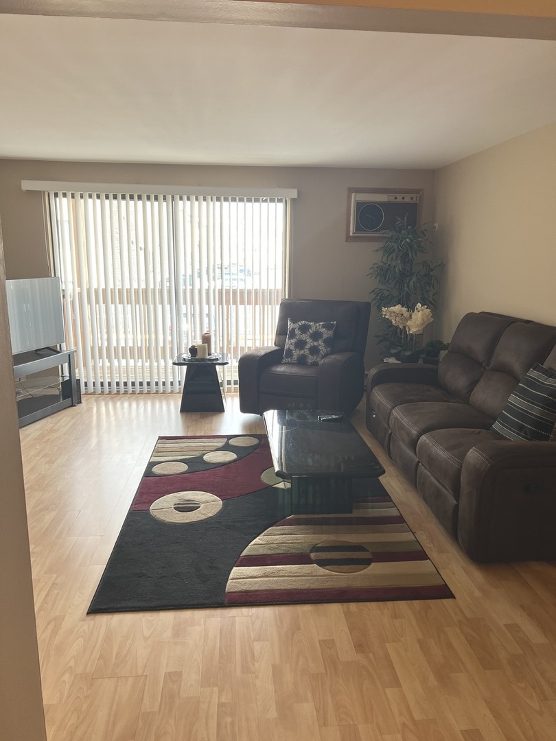 5117 North East River Road, Unit 2A Chicago, IL 60656 - Photo 8 of 32 a living room with furniture rug and window