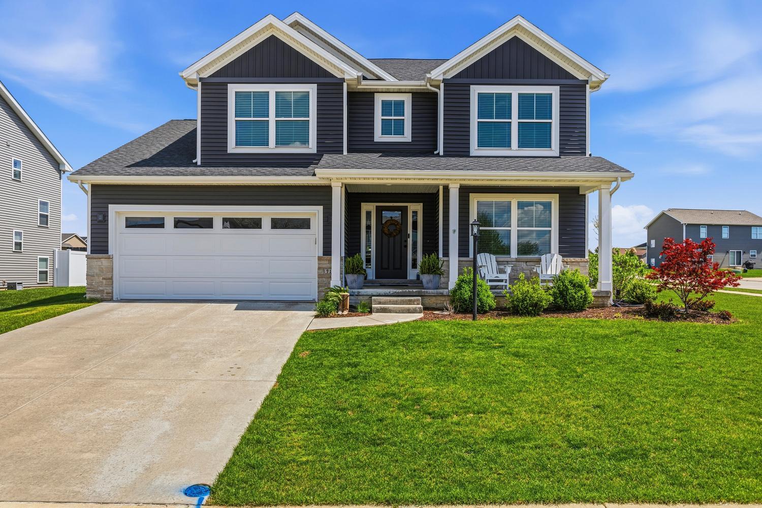 718 Cole Lane Mahomet, IL 61853 - Photo 1 of 44 a front view of a house with a yard and garage