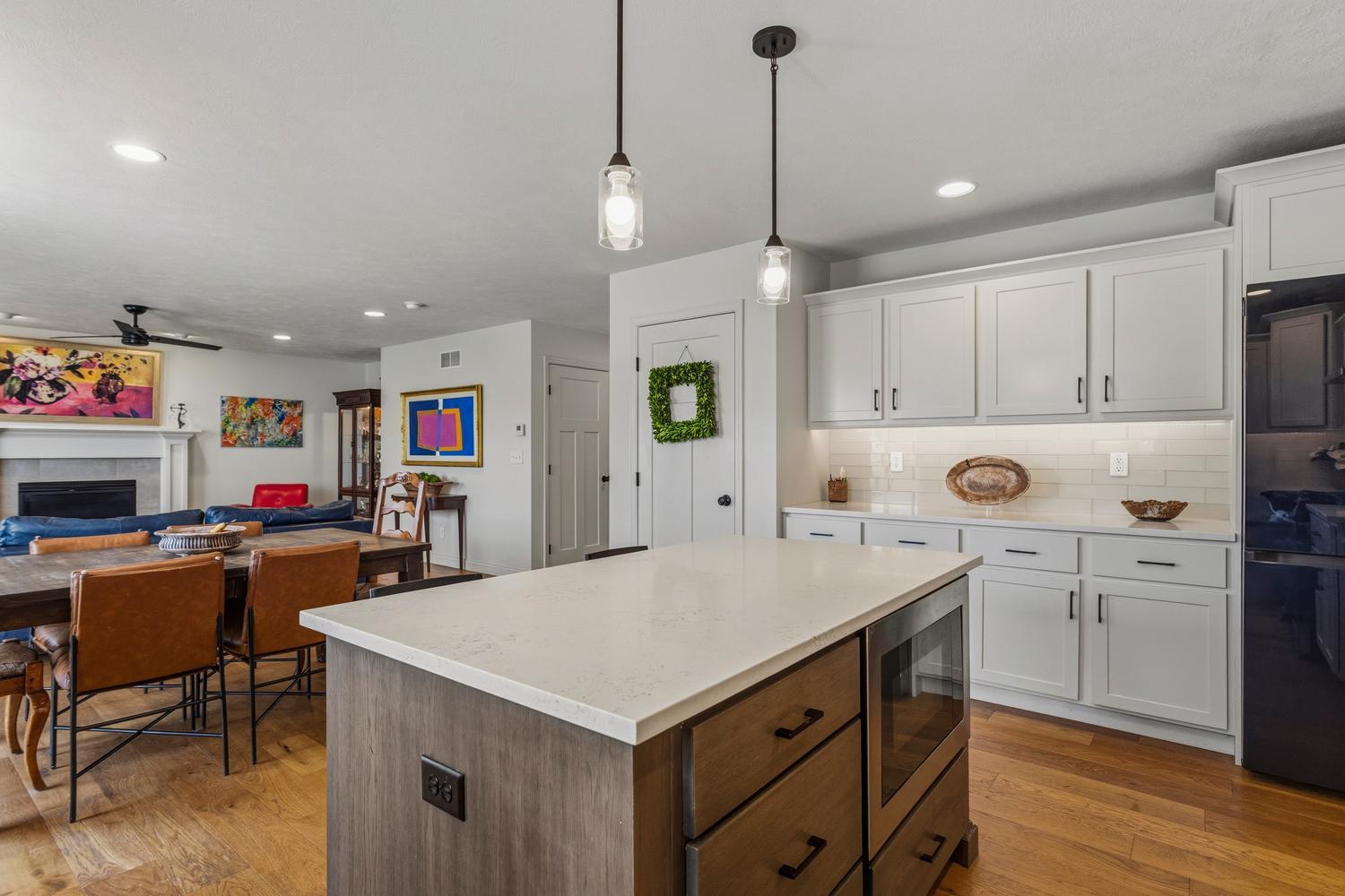 718 Cole Lane Mahomet, IL 61853 - Photo 15 of 44 a kitchen that has a lot of cabinets in it and wooden floors