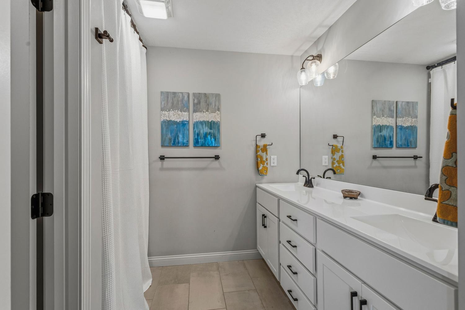 718 Cole Lane Mahomet, IL 61853 - Photo 23 of 44 a spacious bathroom with a double vanity sink a mirror and a shower
