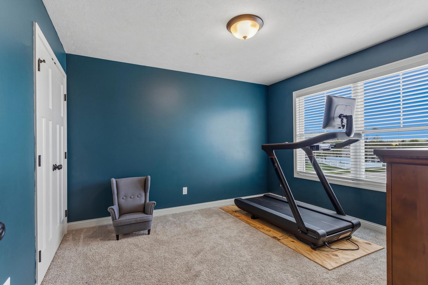718 Cole Lane Mahomet, IL 61853 - Photo 27 of 44 a room with gym equipment and a window