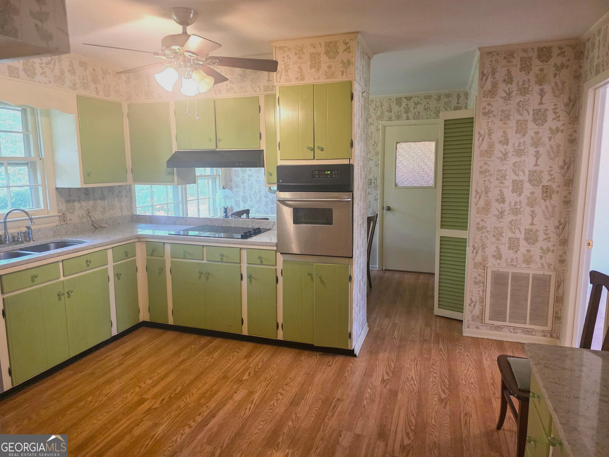 1712 Briarcliff Road Milledgeville, GA 31061 - Photo 8 of 38 a kitchen with a sink cabinets and wooden floor